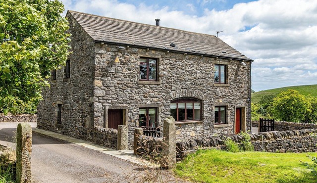 An 1800’s barn conversion with beams, exposed stonework and flagged floors.